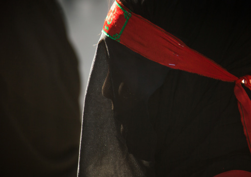 Iranian shiite muslim woman mourning imam Hussein on the day of Tasua with her face covered by a veil, Lorestan Province, Khorramabad, Iran