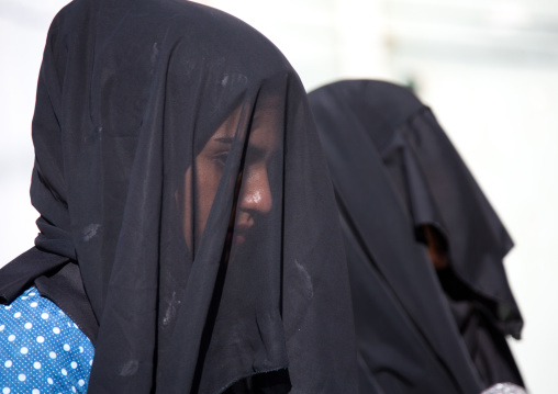 Iranian shiite muslim women with their faces hidden by a veil mourning Imam Hussein on Tasua during the Chehel Manbar ceremony one day before Ashura, Lorestan Province, Khorramabad, Iran