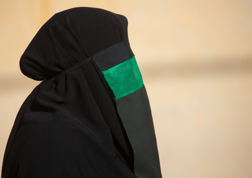 Iranian shiite muslim woman with her face hidden by a veil mourning Imam Hussein on Tasua during the Chehel Manbar ceremony one day before Ashura, Lorestan Province, Khorramabad, Iran