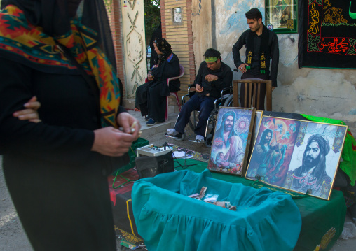 Man in wheelchair collects money during the shiite Chehel Manbar ceremony one day before Ashura, Lorestan Province, Khorramabad, Iran