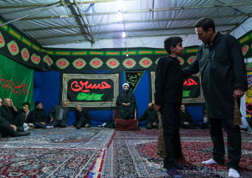 Iranian shiite muslim men listening to a Mullah who preaches during Muharram, Central County, Theran, Iran