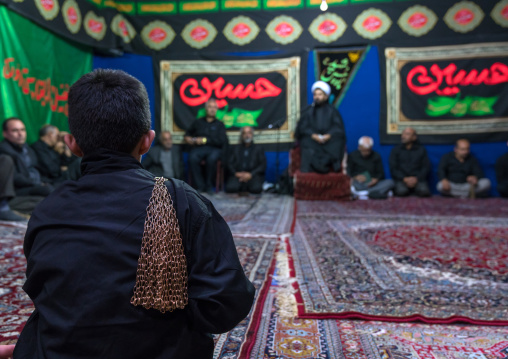 Iranian shiite muslim men listening to a Mullah who preaches during Muharram, Central County, Theran, Iran