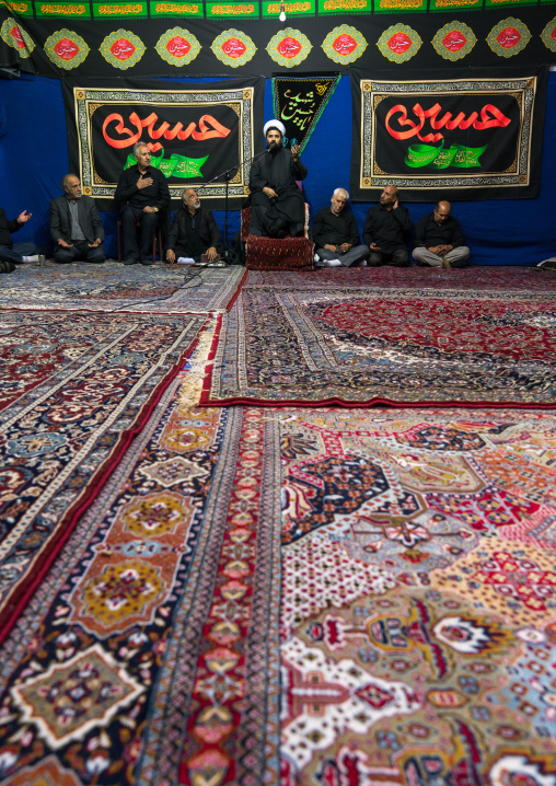 Iranian shiite muslim men listening to a Mullah who preaches during Muharram, Central County, Theran, Iran