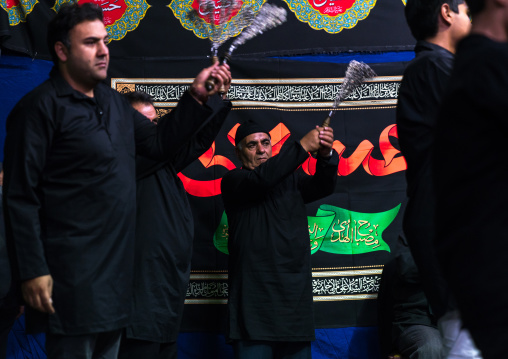 Iranian shiite muslim men beating themselves with iron chains to commemorate Ashura, Central County, Theran, Iran