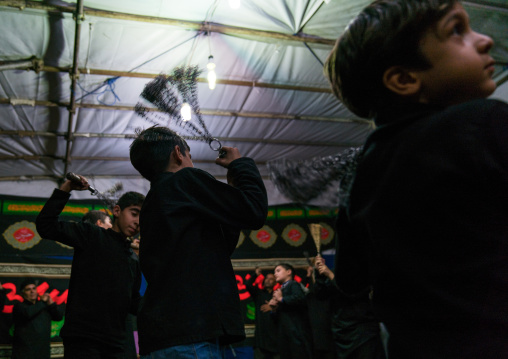 Iranian shiite muslim men beating themselves with iron chains to commemorate Ashura, Central County, Theran, Iran