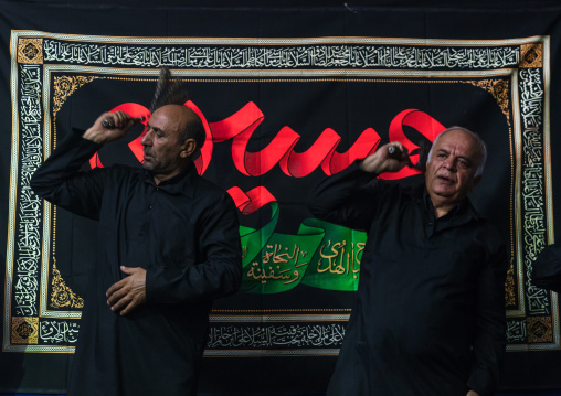 Iranian shiite muslim men beating themselves with iron chains to commemorate Ashura, Central County, Theran, Iran