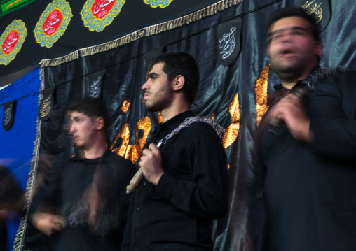 Iranian shiite muslim men beating themselves with iron chains to commemorate Ashura, Central County, Theran, Iran