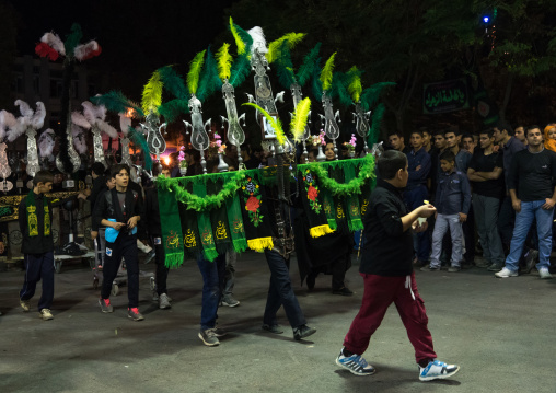 Iranian shiite muslim children carrying an alam during Muharram, Lorestan Province, Khorramabad, Iran