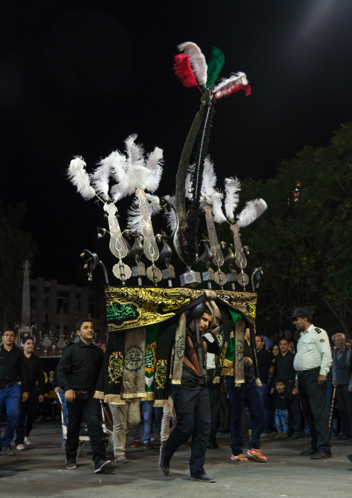 Iranian shiite muslim children carrying an alam during Muharram, Lorestan Province, Khorramabad, Iran