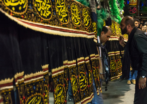 Iranian shiite muslim men carrying an alam during Muharram, Lorestan Province, Khorramabad, Iran