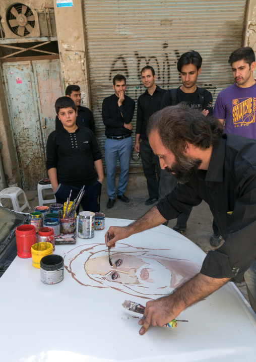 An artist paints the portrait of Abbas Bin Ali on a car for Ashura celebrations to commemorate the martyrdom anniversary of Hussein, Lorestan Province, Khorramabad, Iran