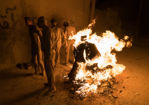 Iranian shiite muslim men gather around a bonfire after rubbing mud on their bodies during the Kharrah Mali ritual to mark the Ashura ceremony, Lorestan Province, Khorramabad, Iran