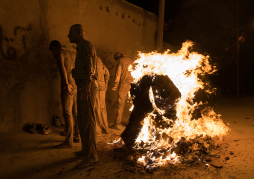 Iranian shiite muslim men gather around a bonfire after rubbing mud on their bodies during the Kharrah Mali ritual to mark the Ashura ceremony, Lorestan Province, Khorramabad, Iran