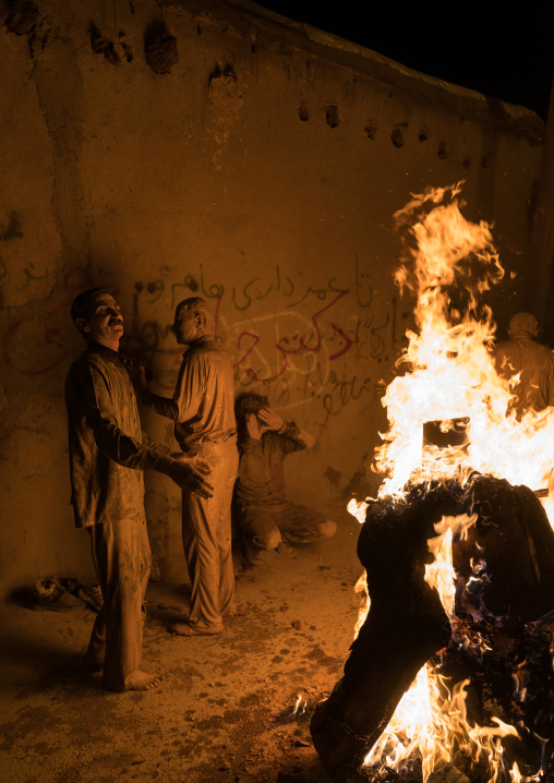 Iranian shiite muslim men gather around a bonfire after rubbing mud on their bodies during the Kharrah Mali ritual to mark the Ashura ceremony, Lorestan Province, Khorramabad, Iran