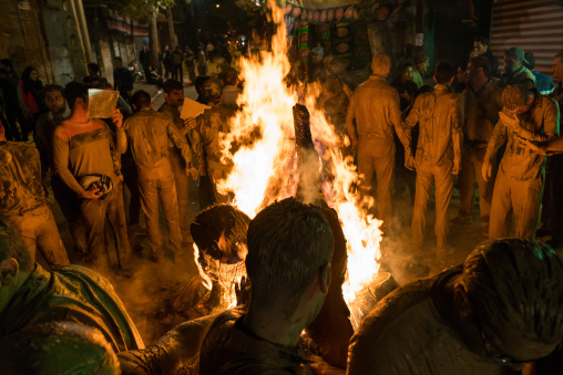 Iranian shiite muslim men gather around a bonfire after rubbing mud on their bodies during the Kharrah Mali ritual to mark the Ashura ceremony, Lorestan Province, Khorramabad, Iran