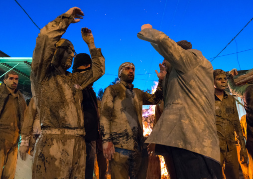 Iranian shiite muslim men gather around a bonfire after rubbing mud on their bodies during the Kharrah Mali ritual to mark the Ashura ceremony, Lorestan Province, Khorramabad, Iran