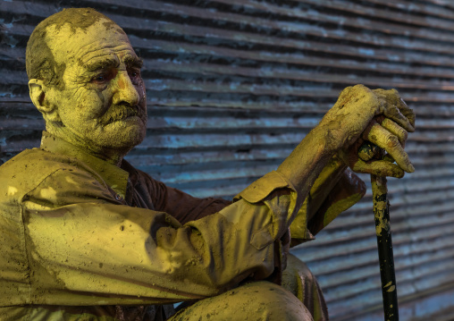 Iranian shiite muslim man crying after rubbing mud on his body during the Kharrah Mali ritual to mark the Ashura ceremony, Lorestan Province, Khorramabad, Iran