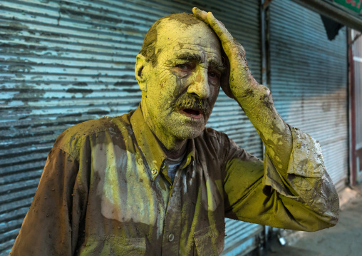 Iranian shiite muslim man crying after rubbing mud on his body during the Kharrah Mali ritual to mark the Ashura ceremony, Lorestan Province, Khorramabad, Iran