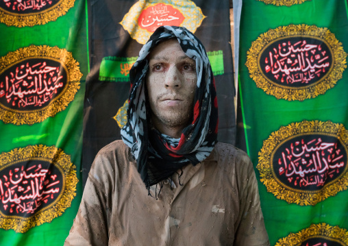 Iranian shiite muslim man after rubbing mud on his body during the Kharrah Mali ritual to mark the Ashura ceremony, Lorestan Province, Khorramabad, Iran