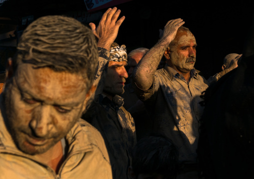 Iranian shiite muslim men with mud stains during the Ashura day, Lorestan Province, Khorramabad, Iran