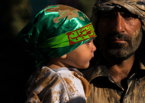 Iranian shiite muslim toddler dressed for Muharram with his father, Lorestan Province, Khorramabad, Iran