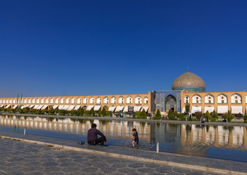 Father and son in front of Sheikh Lutfollah Mosque standing on the eastern side of Naghsh-i Jahan Square, Isfahan Province, Isfahan, Iran