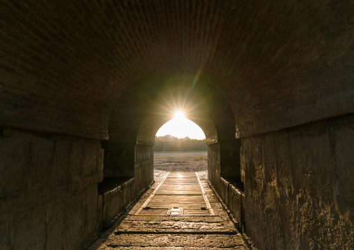 Sun coming inside Khaju bridge Pol-e Khaju over dry Zayandeh river, Isfahan Province, Isfahan, Iran