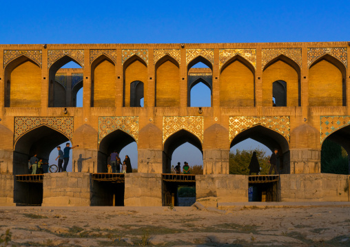 People walking on Khaju bridge Pol-e Khaju over dry Zayandeh river, Isfahan Province, Isfahan, Iran