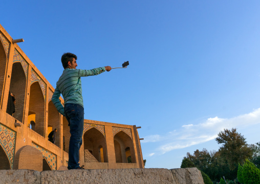 Iranian man taking a selfie on Khaju bridge Pol-e Khaju, Isfahan Province, Isfahan, Iran