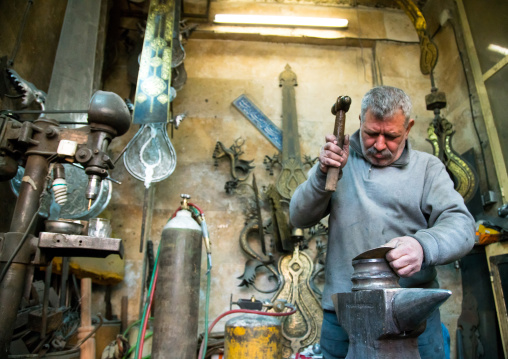 master safar fooladgar creating an alam in his workshop, Central district, Tehran, Iran