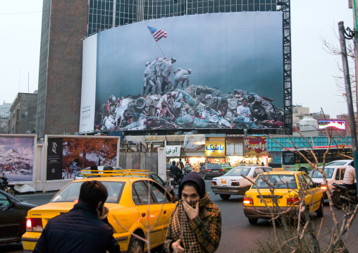 parody of raising the flag on iwo jima historic picture on valiasr square showing american marines on dead bodies, Central district, Tehran, Iran