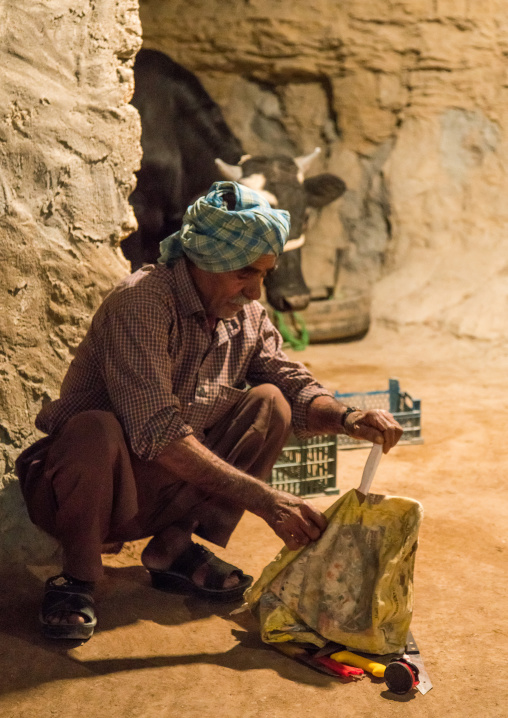 butcher preparing the knives before the slaughter of a cow for a wedding, Qeshm Island, Tabl , Iran