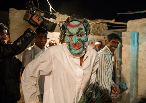 man wearing horror mask during a traditional wedding, Qeshm Island, Tabl , Iran