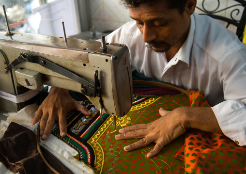 tailor using a sewing machine to make embroideries, Qeshm Island, Salakh, Iran