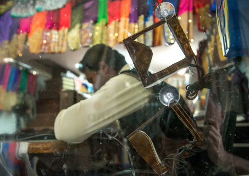 burqas in front of a tailor using a sewing machine to make embroideries, Qeshm Island, Salakh, Iran