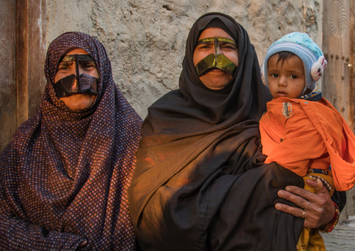 bandari women wearing the traditional masks called the burqas with a moustache shape, Qeshm Island, Salakh, Iran