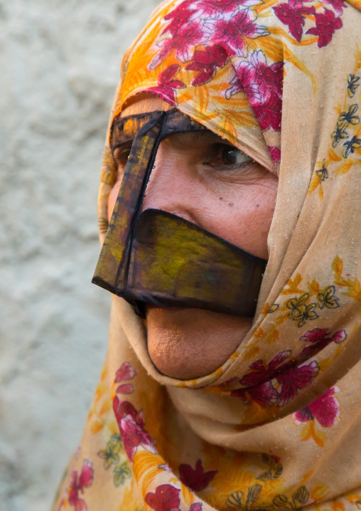 a bandari woman wearing a traditional mask called the burqa with a moustache shape, Qeshm Island, Salakh, Iran