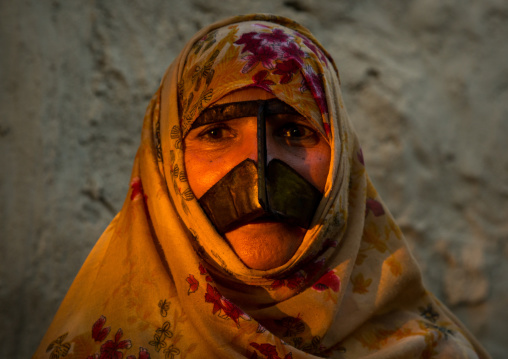 a bandari woman wearing a traditional mask called the burqa with a moustache shape, Qeshm Island, Salakh, Iran