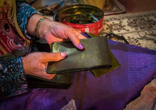 a bandari woman showing how to make a burqa mask, Qeshm Island, Salakh, Iran