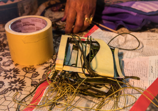 a bandari woman making a traditional burqa mask, Qeshm Island, Salakh, Iran