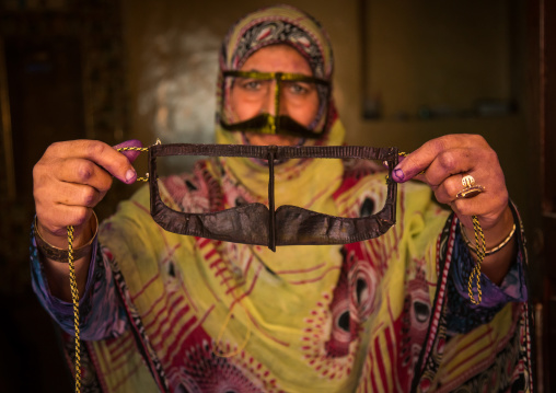 a bandari woman wearing a traditional mask called the burqa with a moustache shape, Qeshm Island, Salakh, Iran