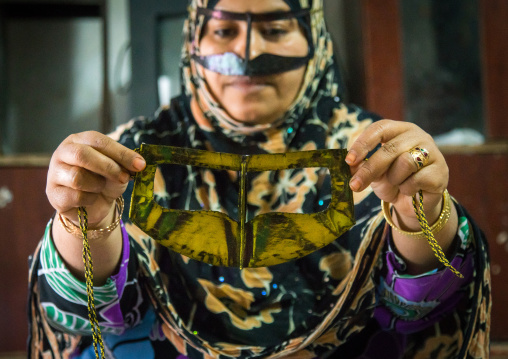 a bandari woman wearing a traditional mask called the burqa with a moustache shape, Qeshm Island, Salakh, Iran