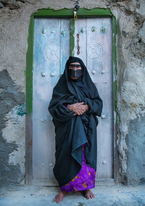 an old bandari woman wearing a traditional mask called the burqa, Qeshm Island, Salakh, Iran