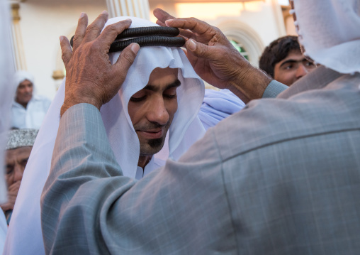 groom changing his clothes to wear new ones during the wedding ceremony, Hormozgan, Bandar-e Kong, Iran