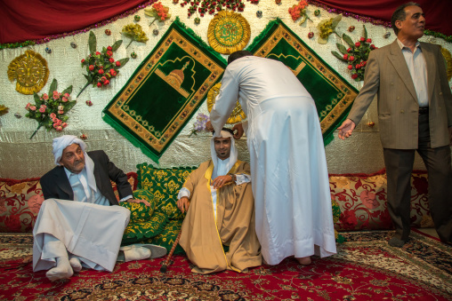 groom posing with his father in his new traditional clothes during a wedding ceremony, Hormozgan, Bandar-e Kong, Iran