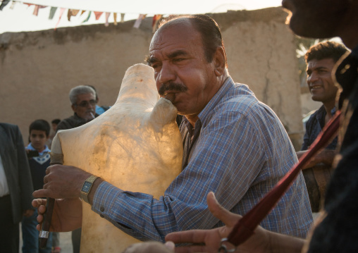 men dancing and playing sheep skin pipe bag during a wedding ceremony, Hormozgan, Kushkenar, Iran