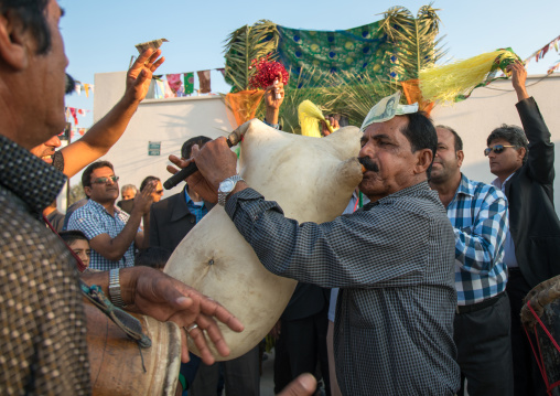 men playing sheep skin pipe bag during a wedding ceremony, Hormozgan, Kushkenar, Iran