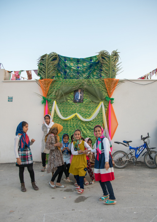 girls in front of a set for a wedding in the street, Hormozgan, Kushkenar, Iran