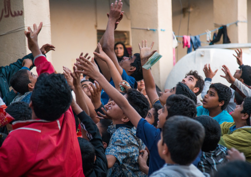 kids collecting sweets during a wedding, Hormozgan, Kushkenar, Iran