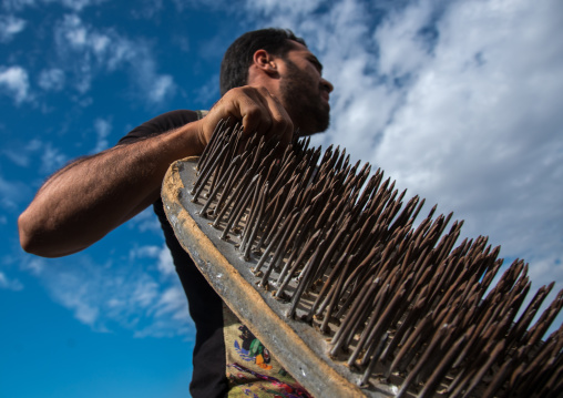 iranian artist carrying a nail bed, Hormozgan, Minab, Iran